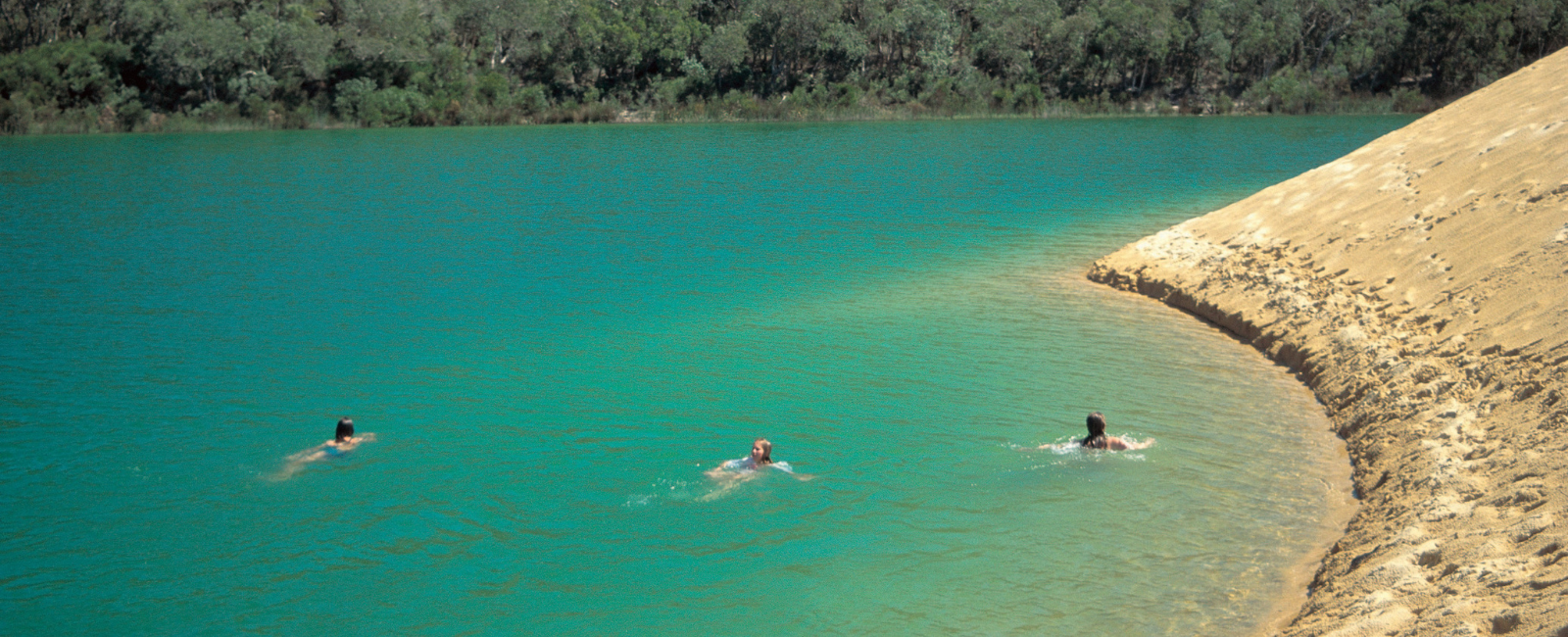People swimming in Lake Wabby, K'gari People swimming in Lake Wabby, K'gari