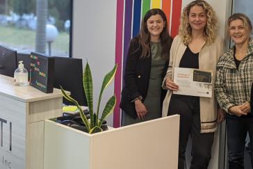 Picture of Amelia Burr with members of the LGBTI Legal Service